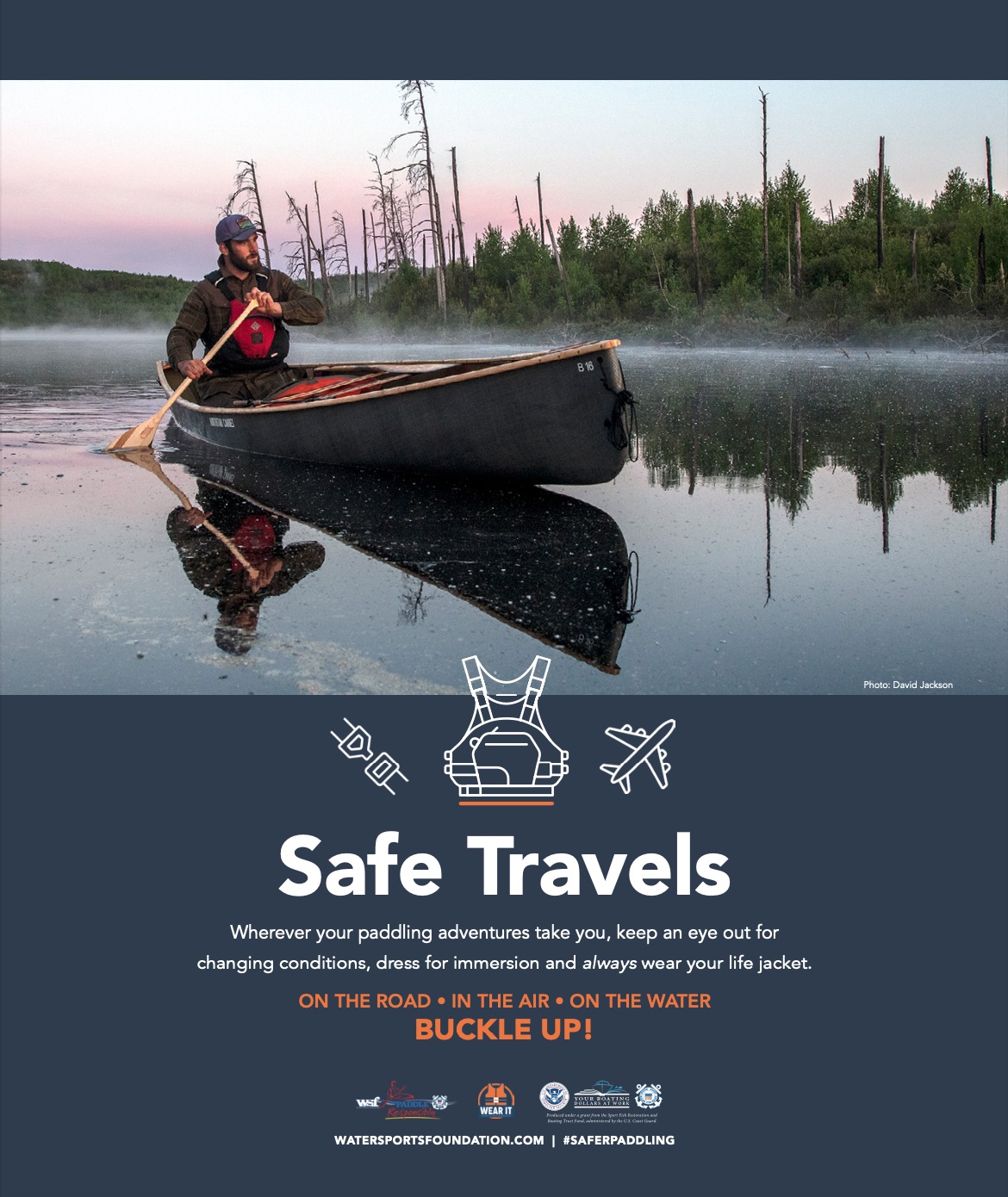 Royalty-free image - A man paddles a canoe on a calm, misty lake surrounded by forest. Text below reads: "Safe Travels. Wherever your paddling adventures take you, keep an eye out for changing conditions, dress for immersion and always wear your life jacket. BUCKLE UP!.